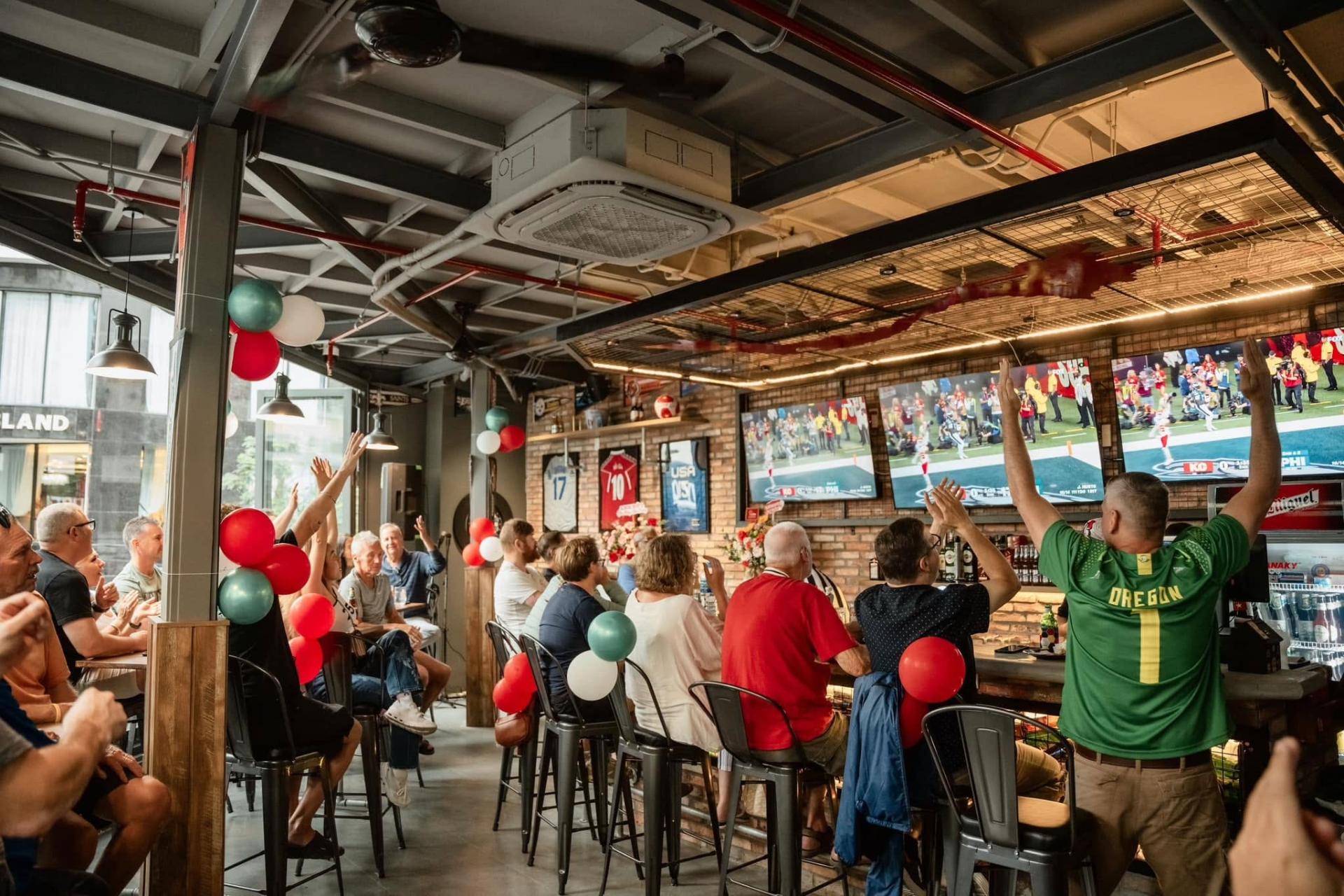 Packed crowd watching sports at Red Buffalo Hub